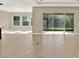 Large living room with tile flooring, neutral paint, and access to the outdoors at 2120 Gwynhurst Blvd, Wesley Chapel, FL 33543