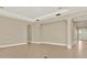 Spacious living room with neutral paint and tile flooring, ready for your personal touch at 2120 Gwynhurst Blvd, Wesley Chapel, FL 33543