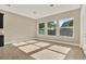 Bright living room featuring neutral paint, beautiful tile floors and large windows at 2120 Gwynhurst Blvd, Wesley Chapel, FL 33543