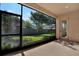 Screened patio offering an outdoor living space with views of the green lawn and fenced yard at 2120 Gwynhurst Blvd, Wesley Chapel, FL 33543