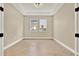 Bright and spacious room with tile flooring and two large windows at 2120 Gwynhurst Blvd, Wesley Chapel, FL 33543