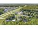 Aerial view of the property and neighborhood near the highway, surrounded by greenery at 2121 Odessa Gardens Ln, Odessa, FL 33556