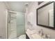 This bathroom features a shower, single vanity sink and modern fixtures at 2121 Odessa Gardens Ln, Odessa, FL 33556