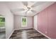 This bedroom includes woodgrain vinyl floors, a window and standard closet at 2121 Odessa Gardens Ln, Odessa, FL 33556