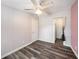 This bedroom includes woodgrain vinyl floors, closet and light ceiling fan at 2121 Odessa Gardens Ln, Odessa, FL 33556