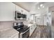 Modern kitchen with white cabinets, stainless steel appliances, granite countertops, and ample natural light at 2121 Odessa Gardens Ln, Odessa, FL 33556