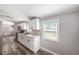 This kitchen has white cabinets, stainless steel appliances and a view to the outside at 2121 Odessa Gardens Ln, Odessa, FL 33556
