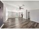 Open living area with wood-look floors, natural light, and access to other rooms of the home at 2121 Odessa Gardens Ln, Odessa, FL 33556