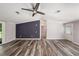 Open living space with wood-look floors, a sliding door, and an exterior door to the outside at 2121 Odessa Gardens Ln, Odessa, FL 33556