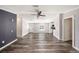 A view of the living room, with woodgrain vinyl floors and an entry into the kitchen at 2121 Odessa Gardens Ln, Odessa, FL 33556