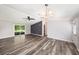 Spacious living area featuring wood-look flooring, a sliding glass door, and access to other rooms at 2121 Odessa Gardens Ln, Odessa, FL 33556