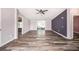 Open-concept living area featuring wood-look flooring, sliding glass doors, and multiple entryways at 2121 Odessa Gardens Ln, Odessa, FL 33556