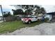 View of a backyard with a parked truck, storage, and a small building at 2410 38Th N Ave, St Petersburg, FL 33713