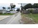 View of the backyard featuring a fence, vehicles, and trees at 2410 38Th N Ave, St Petersburg, FL 33713