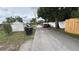 The backyard features a fence, utility containers, and multiple vehicles at 2410 38Th N Ave, St Petersburg, FL 33713