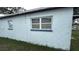 Side exterior showing the side of a single-story home and small lawn at 2410 38Th N Ave, St Petersburg, FL 33713