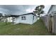 Side yard showing the side of a single-story home with a wooden fence at 2410 38Th N Ave, St Petersburg, FL 33713