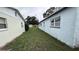 Side yard showing the side of a single-story home and adjacent property at 2410 38Th N Ave, St Petersburg, FL 33713