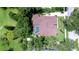 Aerial view of a private residence featuring a screened-in pool, mature trees, and a well-maintained lawn at 2504 Oak Landing Dr, Brandon, FL 33511