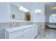 Bright bathroom featuring a marble vanity with dual sinks, a clawfoot tub, and elegant lighting fixtures at 2504 Oak Landing Dr, Brandon, FL 33511