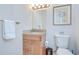 Bathroom featuring a light wood vanity with a granite counter and decorative pulls and fixtures at 2504 Oak Landing Dr, Brandon, FL 33511