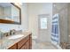 Bathroom with granite countertop vanity, and walk-in shower with a shower curtain at 2504 Oak Landing Dr, Brandon, FL 33511