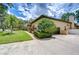 Stunning single-Gathering home boasting a well-manicured lawn, lush landscaping, and a convenient two-car garage at 2504 Oak Landing Dr, Brandon, FL 33511