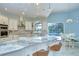 Bright, white kitchen featuring a center island, stainless steel sink, and pool view at 2504 Oak Landing Dr, Brandon, FL 33511