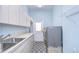 Well-equipped laundry room featuring modern appliances, ample counter space, and storage cabinets at 2504 Oak Landing Dr, Brandon, FL 33511
