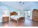 Main bedroom featuring a tray ceiling, wood floors, and access to outdoor patio at 2504 Oak Landing Dr, Brandon, FL 33511