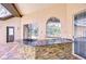 Outdoor kitchen features granite countertops, stone surround, and cooking equipment at 2504 Oak Landing Dr, Brandon, FL 33511