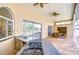 Outdoor kitchen boasts a granite counter, sink, gas range, and ceiling fans for comfortable dining at 2504 Oak Landing Dr, Brandon, FL 33511