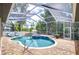 Inviting screened-in pool and spa area surrounded by brick pavers and lush greenery, perfect for relaxation and entertainment at 2504 Oak Landing Dr, Brandon, FL 33511