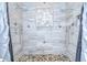 A luxurious shower featuring dual shower heads, decorative tiling, pebble floor and a built-in niche at 2504 Oak Landing Dr, Brandon, FL 33511
