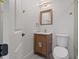 Bathroom featuring wood vanity, updated fixtures, and a modern tiled shower at 3197 Walnut Ne St, St Petersburg, FL 33704