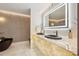 Modern bathroom with dual black basins, a soaking tub, and LED lighting at 3197 Walnut Ne St, St Petersburg, FL 33704