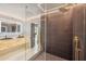 This gorgeous bathroom features a glass enclosed shower, dual black basins, and a illuminated mirror at 3197 Walnut Ne St, St Petersburg, FL 33704