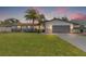 Charming single-story home featuring a manicured lawn and a spacious two-car garage at 3197 Walnut Ne St, St Petersburg, FL 33704