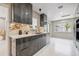 This kitchen features sleek gray cabinetry with marbled countertops and stainless steel appliances at 3197 Walnut Ne St, St Petersburg, FL 33704