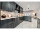 A gray kitchen with marble countertops and stainless steel appliances, with open access to the living room at 3197 Walnut Ne St, St Petersburg, FL 33704