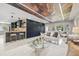 Open-concept living area with modern decor, stylish seating, and a sleek kitchen bar at 3197 Walnut Ne St, St Petersburg, FL 33704
