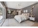 Stylish main bedroom with gray walls, white bedding, modern lighting, and access to the backyard pool area at 3197 Walnut Ne St, St Petersburg, FL 33704