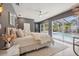 The main bedroom has a view of the screened-in pool, neutral decor, and a ceiling fan at 3197 Walnut Ne St, St Petersburg, FL 33704