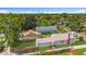 Scenic aerial view capturing the home, backyard, and lush greenery, nestled in a tranquil, wooded neighborhood at 3327 25Th N St, St Petersburg, FL 33713