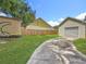 A spacious backyard offers a detached garage, a privacy fence, and beautiful green grass at 3327 25Th N St, St Petersburg, FL 33713
