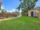 Spacious backyard with shed, driveway, and lush green grass at 3327 25Th N St, St Petersburg, FL 33713