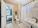 Updated bathroom featuring shower, vanity and view into an adjacent bedroom at 3327 25Th N St, St Petersburg, FL 33713