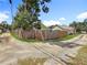 Property featuring a corner lot with a wooden fence and gravel driveway, offering privacy and ample parking space at 3327 25Th N St, St Petersburg, FL 33713
