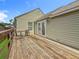 This angle highlights the wood deck with a seating area and access to the home's double doors at 3327 25Th N St, St Petersburg, FL 33713