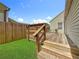 Backyard wooden deck with stairs leading down to the grass and a fenced-in yard at 3327 25Th N St, St Petersburg, FL 33713